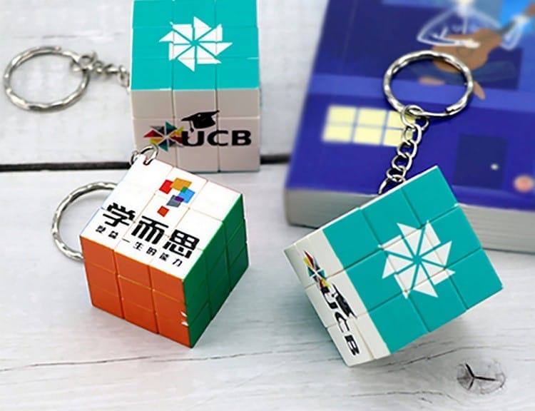 small branded rubiks cubes that may be attached to a key ring and used as a fidget toy