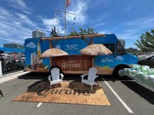 Corona custom sand-print mat under Adirondack chairs at a beach-themed activation