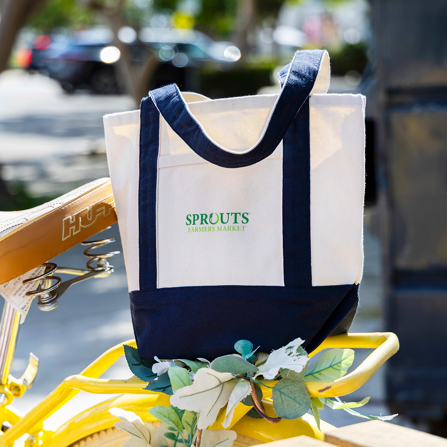 Structured branded canvas mini deck tote with navy contrast handles and custom screen-printed logo