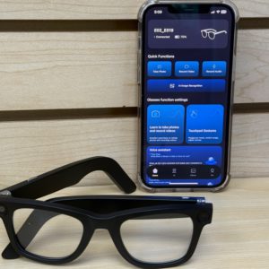 Black smart glasses with AI translation displayed next to phone app