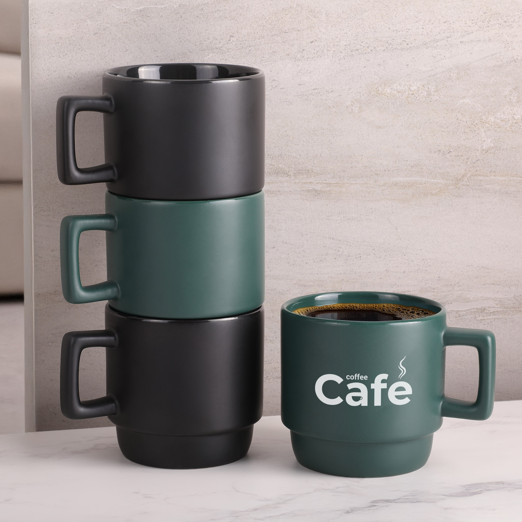 Custom coffee mugs stacked in matte black, cobalt, and red for corporate branding