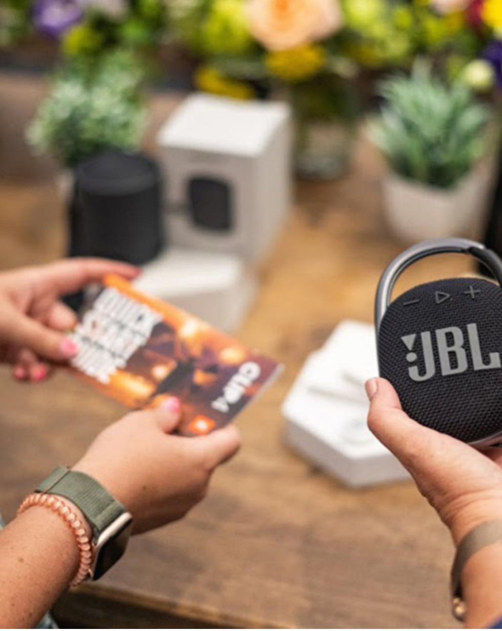 Guest redeeming a JBL speaker gift at an on-site gifting station