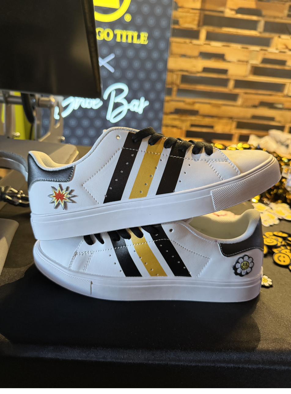 Close-up of custom sneakers with patches at a live shoe bar station