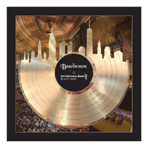 Gold framed custom 12 inch record award with city skyline backer design