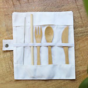 Rolled bamboo cutlery set with fork, spoon, and knife in carry case