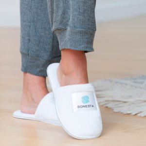 White flannel fuzz slippers with memory foam insole for employee comfort