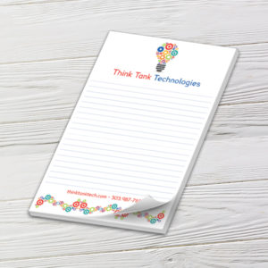 Full-color half-letter hotel notepad with printed logo art and a curled top sheet