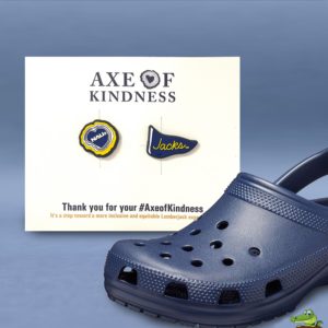 Custom molded shoe charm two-pack on a printed 4x6 card beside a navy clog shoe