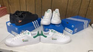 Black and white Adidas Stan Smith custom branded sneakers with heel logos
