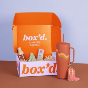 Custom printed new hire kit box filled with crinkle paper, tumbler, and branded items