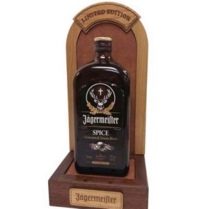 Custom bottle glorifier with an arched wood back panel holding a single liquor bottle