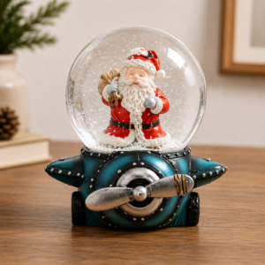 Custom snow globe with a Santa figure on a sculpted, airplane-shaped resin base